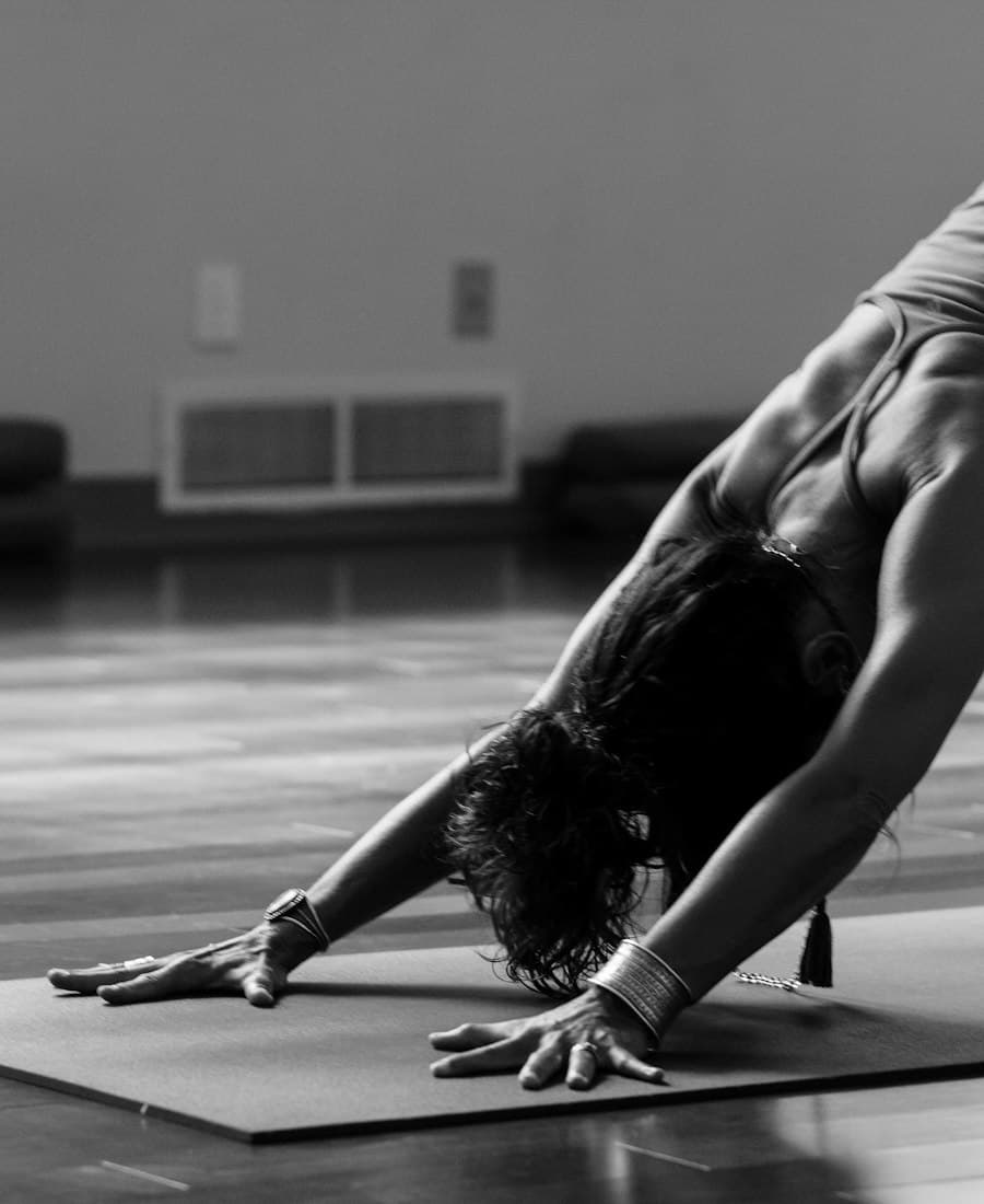 An organic cotton yoga strap with a metal D-ring buckle.